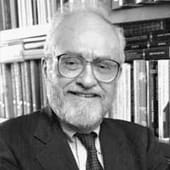 Browder smiling in front of bookshelf